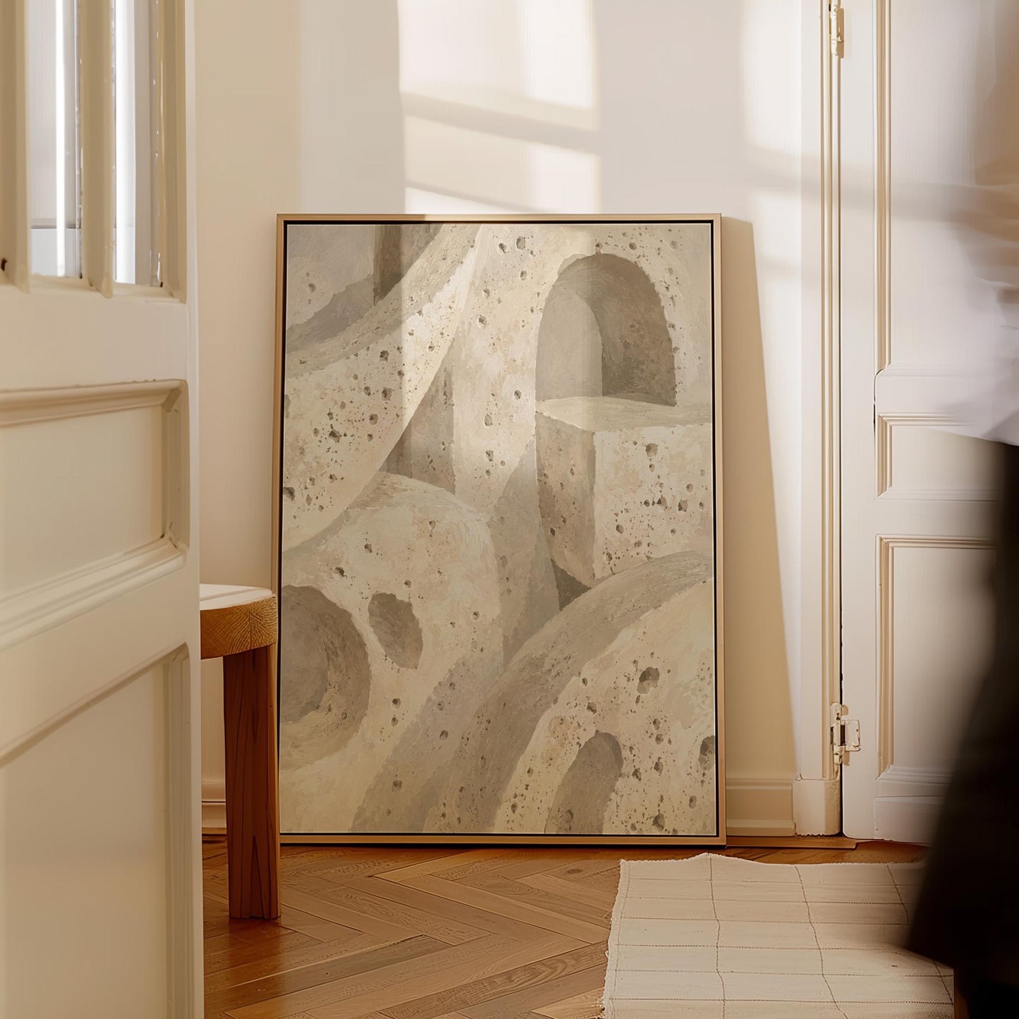 Interlocking arches and organic forms in warm speckled beige, canvas print shown to scale in a furnished room