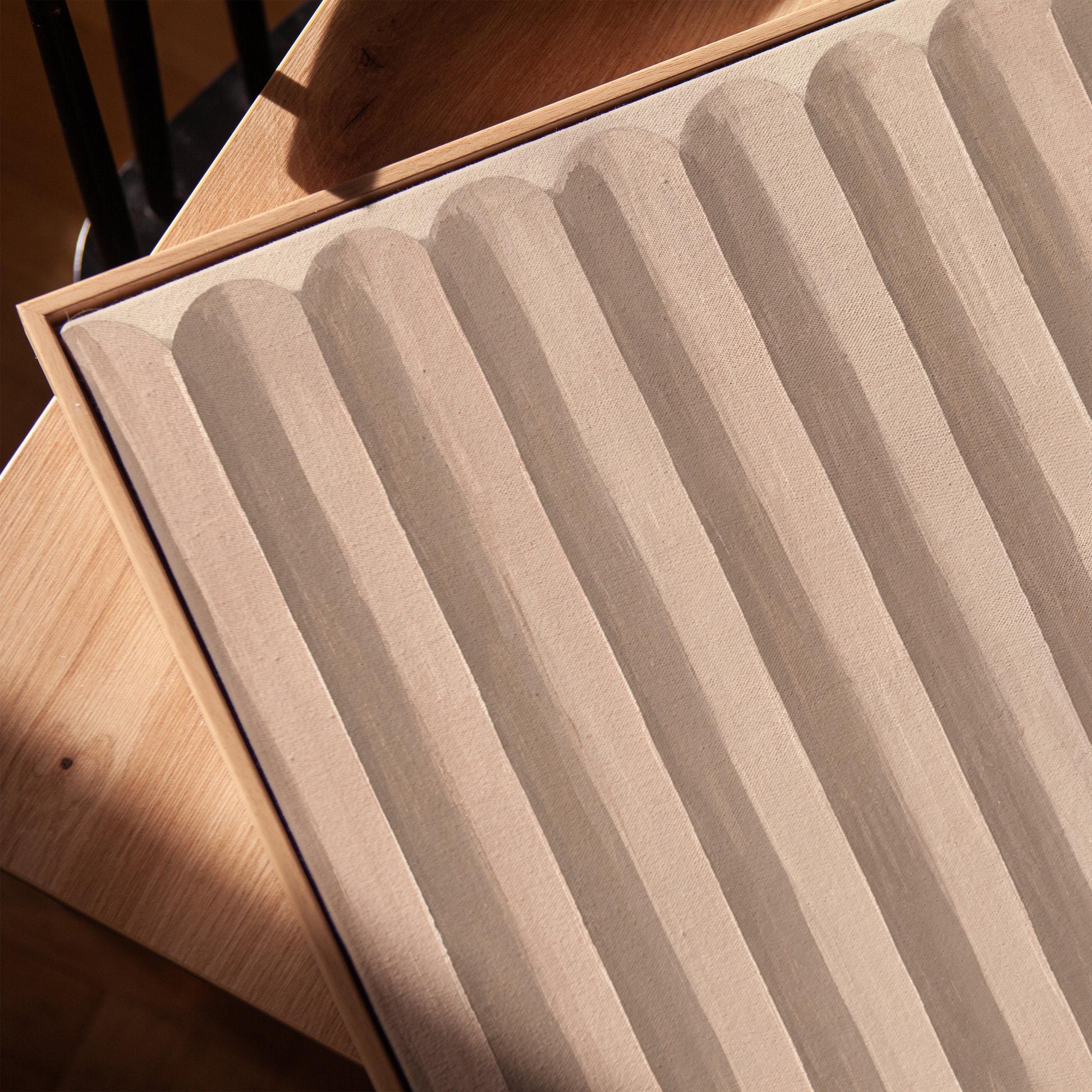 Vertical stripe pattern in blush pink and soft beige, canvas print in a warm, minimally styled interior