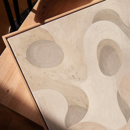 Soft organic flowing shapes in cream and light beige, canvas print in a warm, minimally styled interior