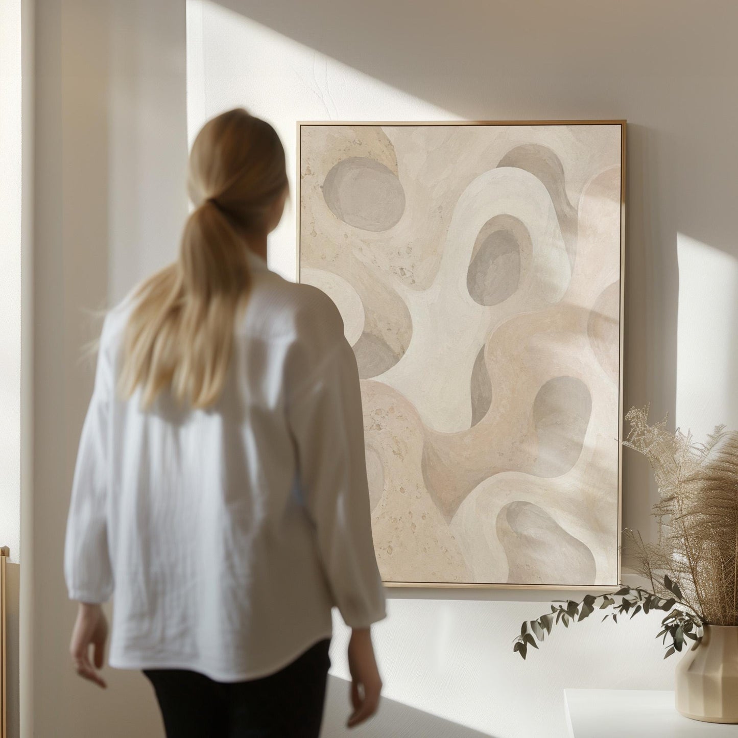 Soft organic flowing shapes in cream and light beige, canvas print presented in a light, minimal room