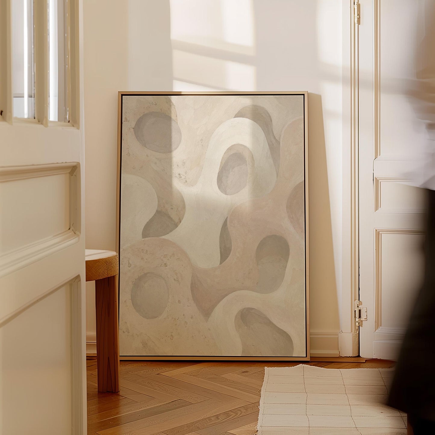 Soft organic flowing shapes in cream and light beige, canvas print on a quiet wall in a considered interior