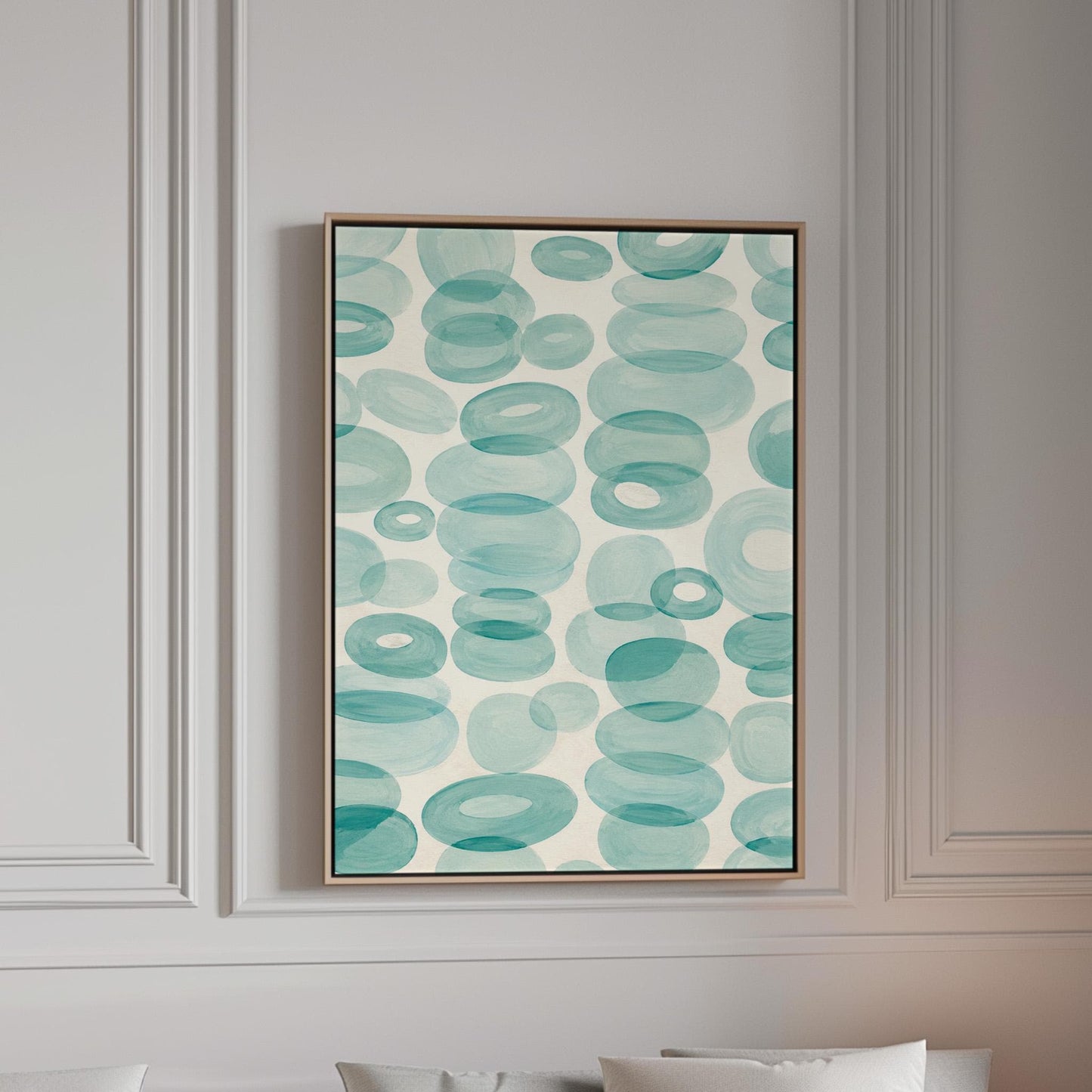 Watercolor rings and ovals in aqua and teal like sea glass, canvas print in a bright room with natural daylight