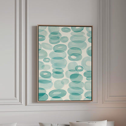 Watercolor rings and ovals in aqua and teal like sea glass, canvas print in a bright room with natural daylight