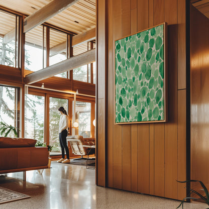 Dense watercolor pebble shapes in mint to emerald green, canvas print on a quiet wall in a considered interior