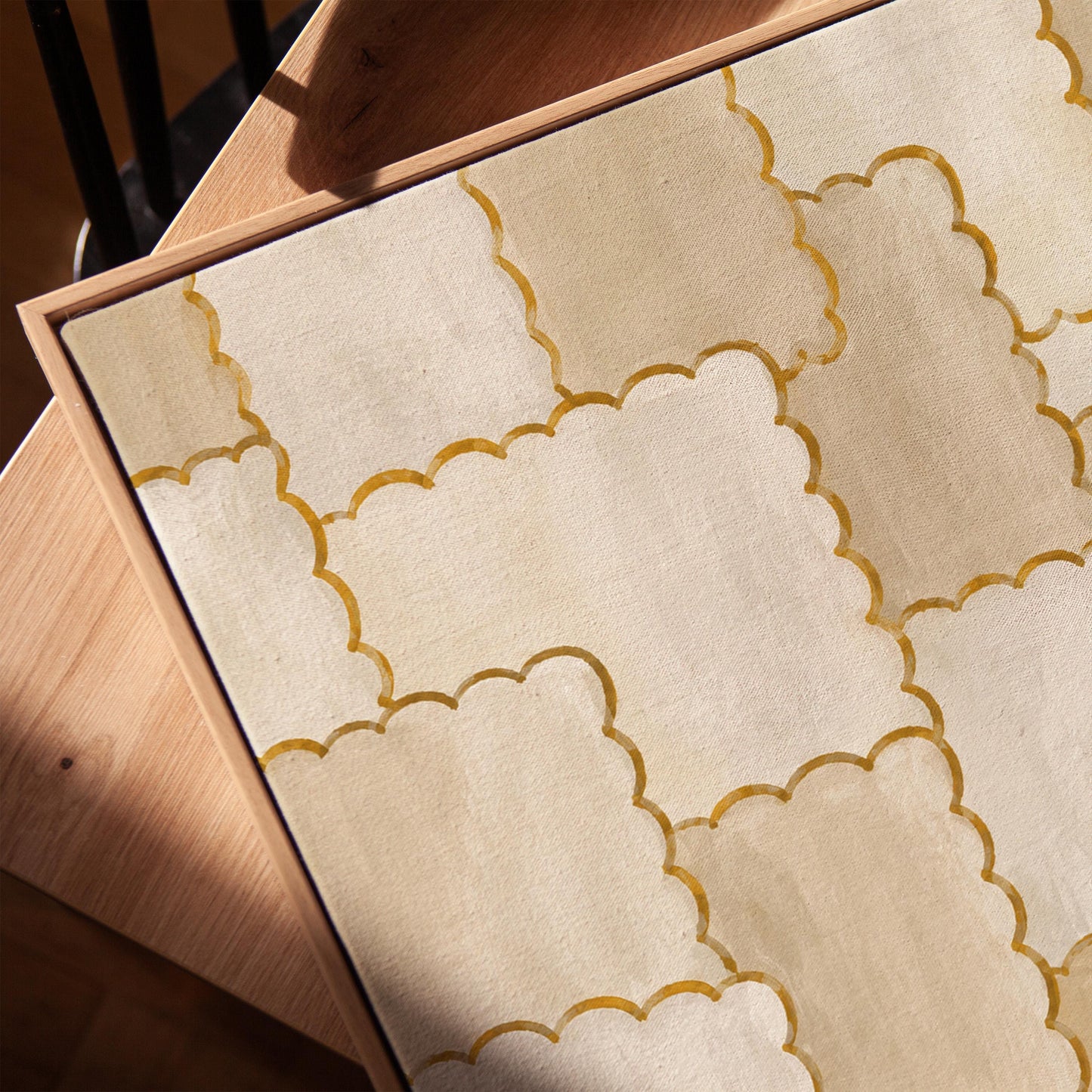 Overlapping tile pattern with scalloped gold edges in beige, canvas print in a warm, minimally styled interior