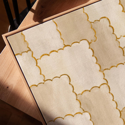 Overlapping tile pattern with scalloped gold edges in beige, canvas print in a warm, minimally styled interior