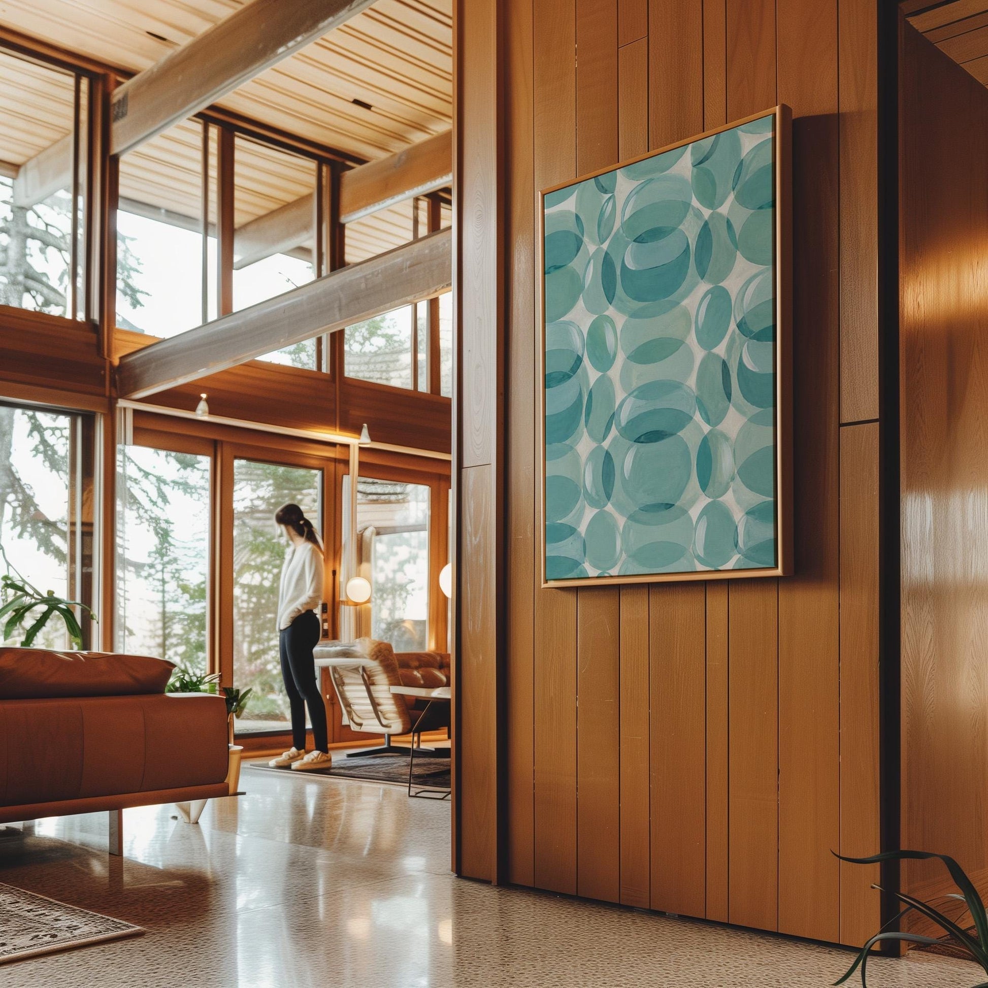 Overlapping translucent circles in teal and aqua tones, canvas print hanging in a calm, modern living space