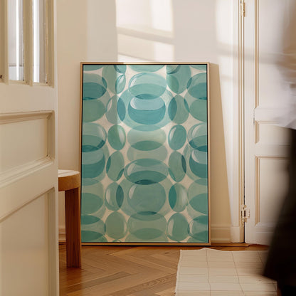Overlapping translucent circles in teal and aqua tones, canvas print seen in a warm interior with natural light