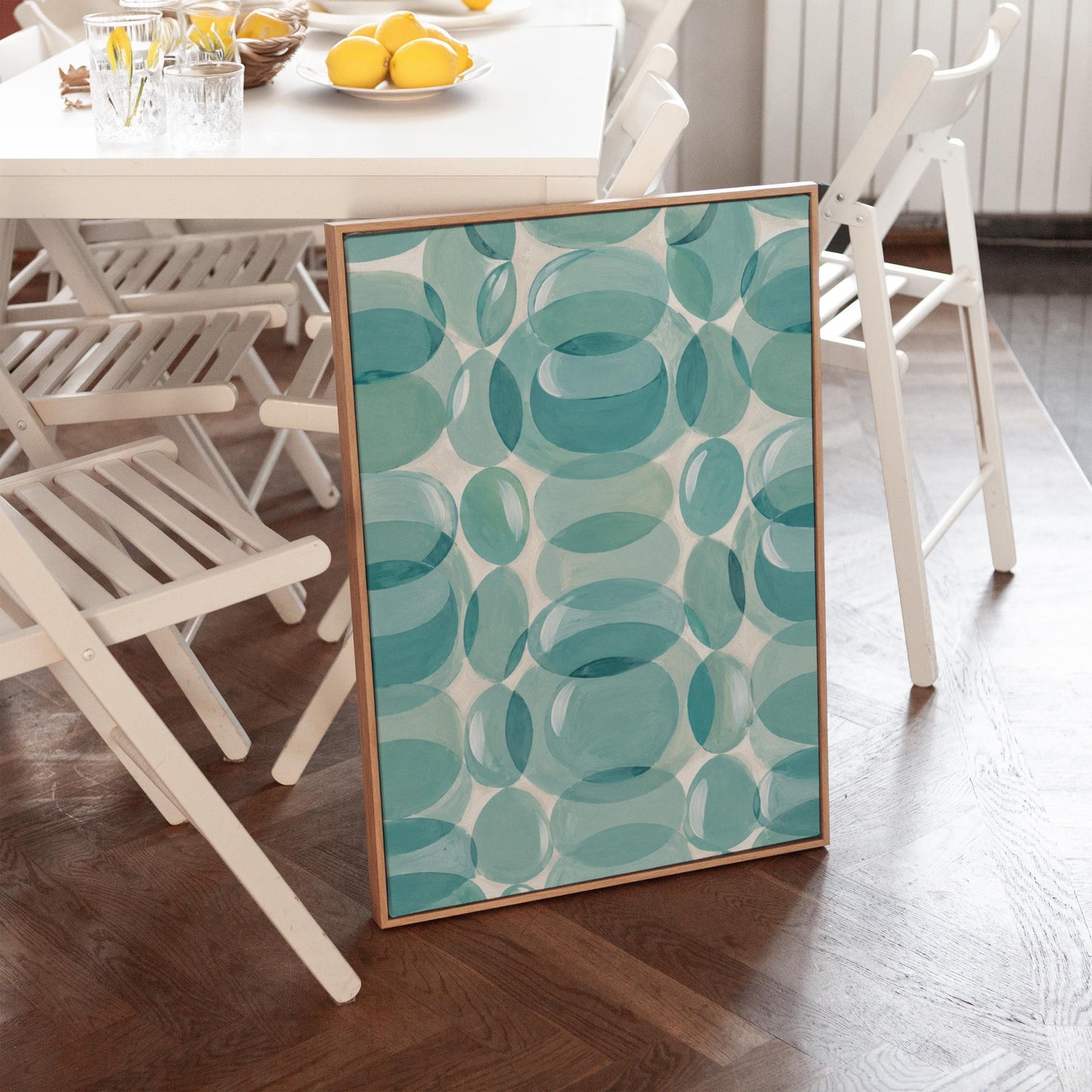 Overlapping translucent circles in teal and aqua tones, canvas print shown to scale in a furnished room