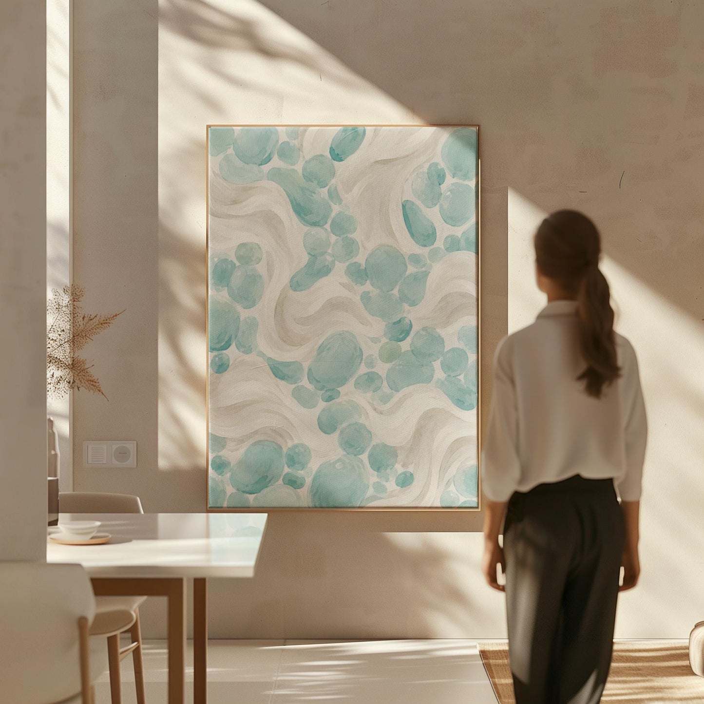 Aqua pebble shapes drifting among soft cream waves, canvas print styled against a soft white wall