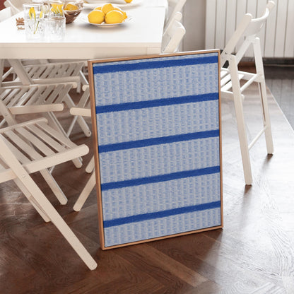Bold cornflower blue stripes on a pale blue background, canvas print styled against a soft white wall