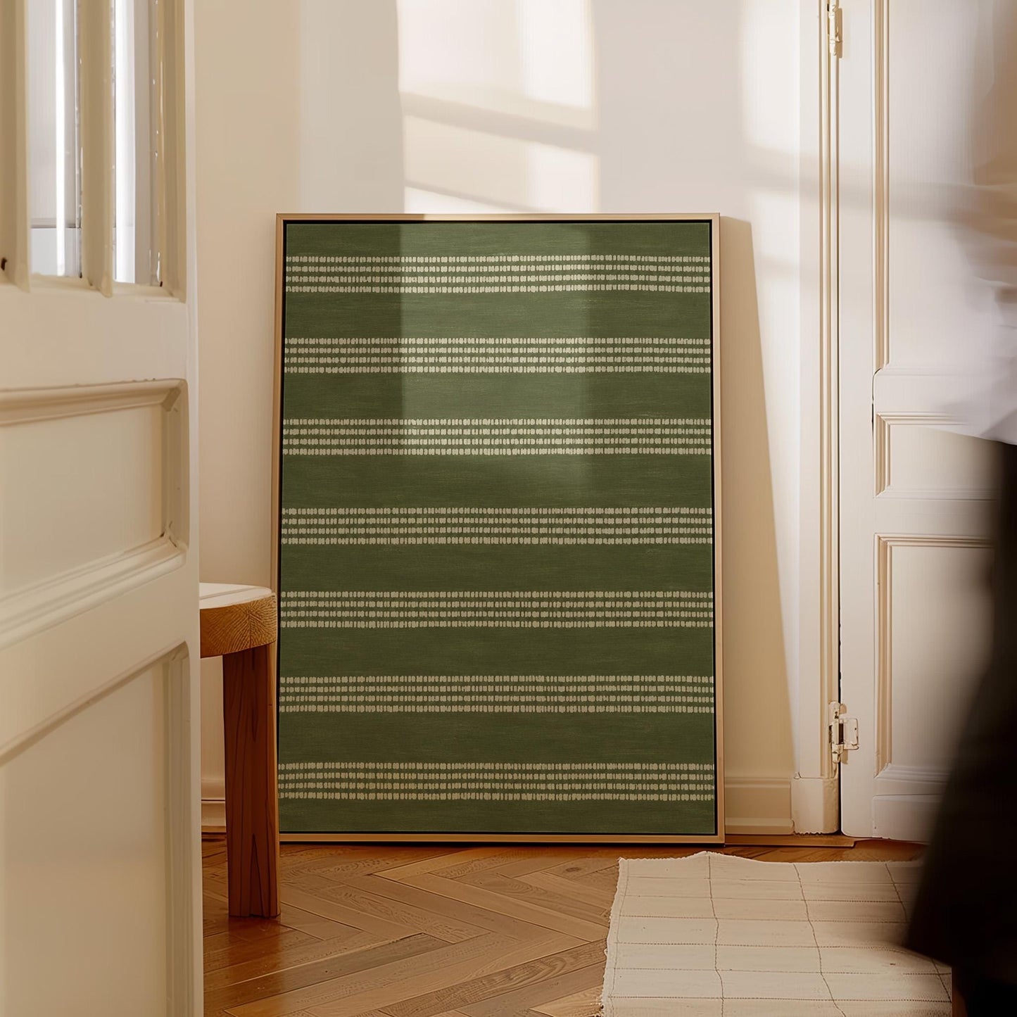 Olive green field with thin cream pinstripe rows, canvas print shown to scale in a furnished room