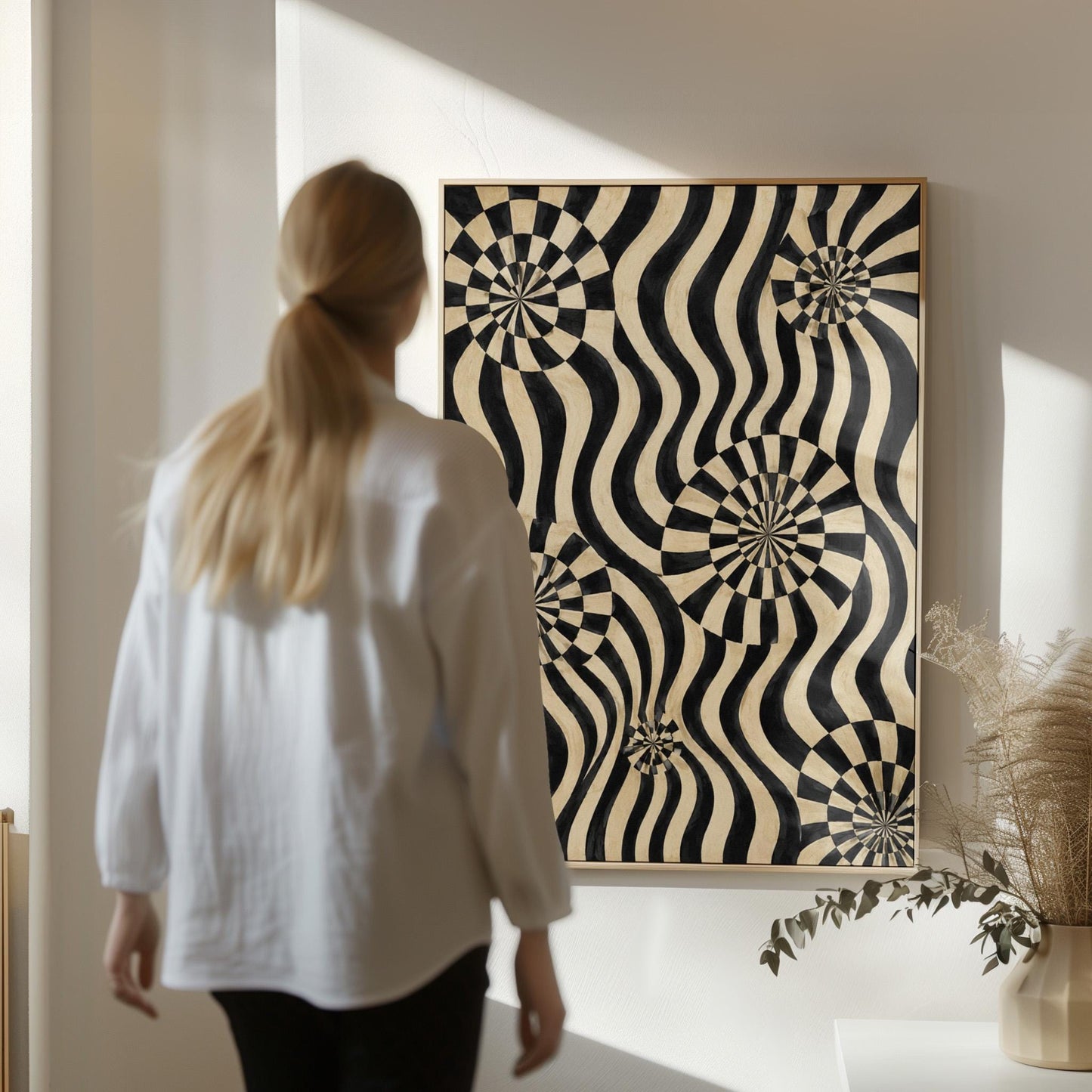 Swirling wavy stripes with spiral discs in black and ivory, canvas print styled against a soft white wall