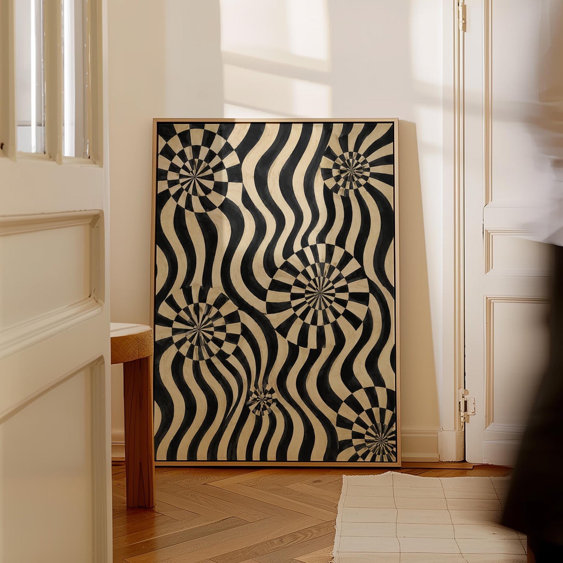 Swirling wavy stripes with spiral discs in black and ivory, canvas print on a quiet wall in a considered interior