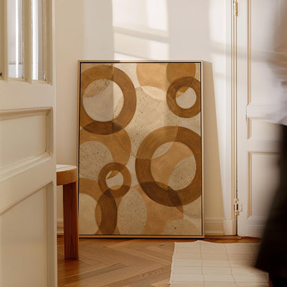 Overlapping translucent circles in amber and terracotta, canvas print hanging in a calm, modern living space