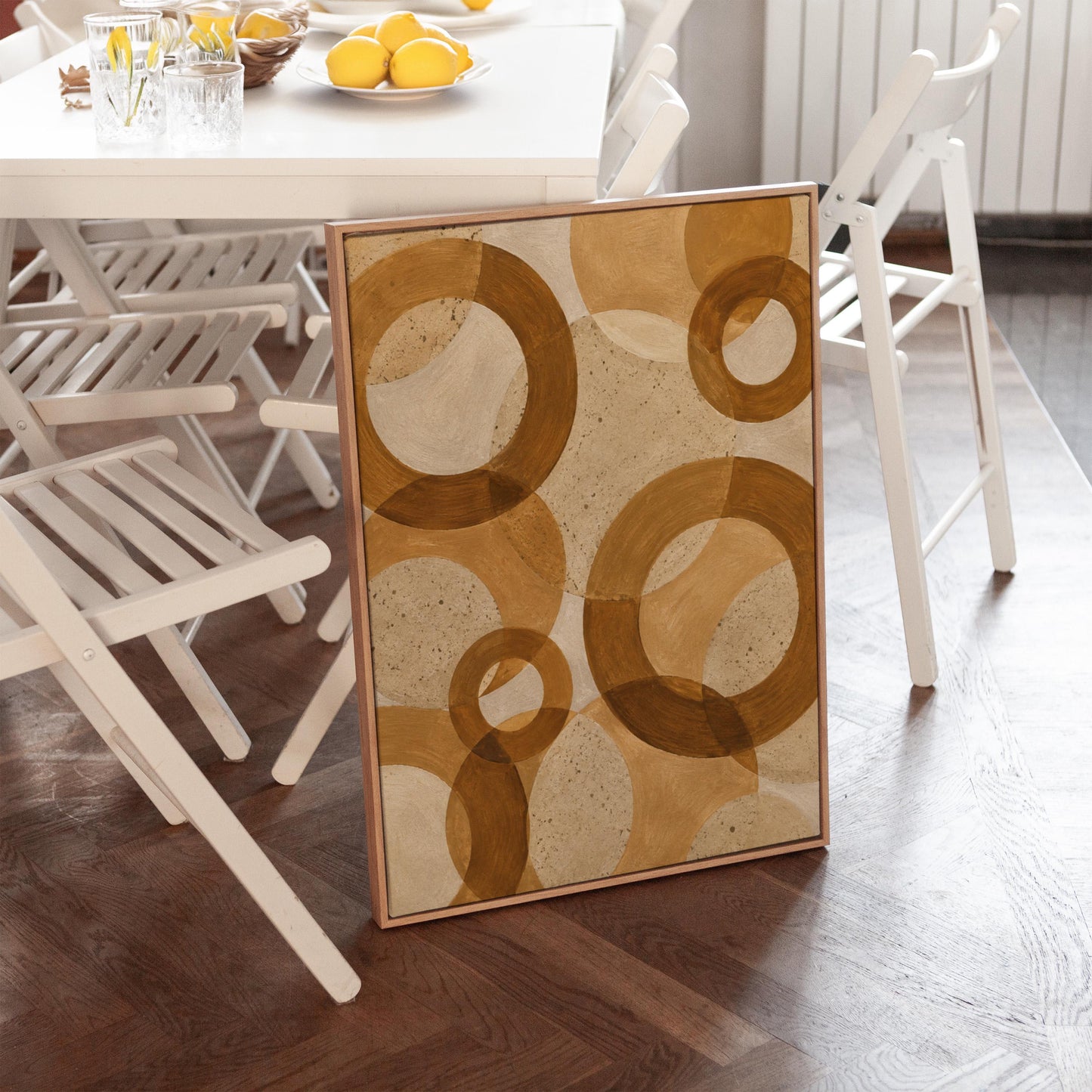 Overlapping translucent circles in amber and terracotta, canvas wall art on a quiet wall in a considered interior