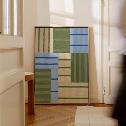Patchwork of sage green fields with periwinkle blue bands, canvas print styled against a soft white wall