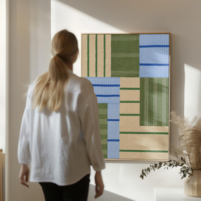 Patchwork of sage green fields with periwinkle blue bands, canvas print seen in a warm interior with natural light