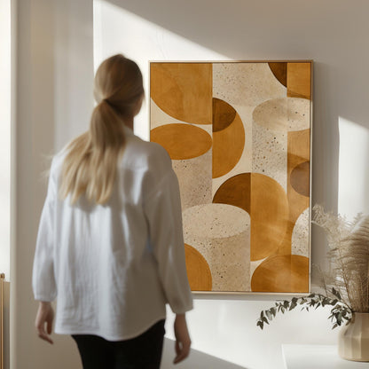 Warm caramel geometric shapes on speckled cream background, canvas print displayed on a neutral wall in a styled interior