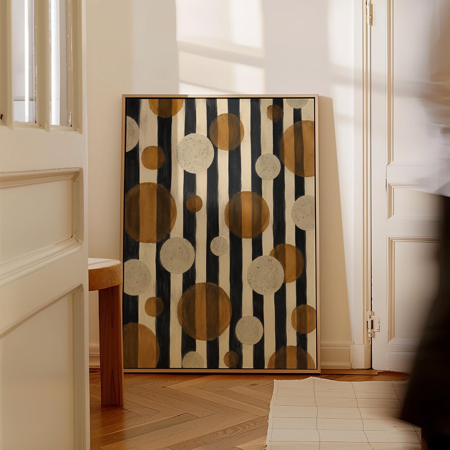Amber and cream circles scattered over black vertical stripes, canvas print styled against a soft white wall