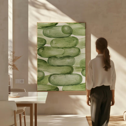 Stacked smooth green stones painted in watercolor, canvas print styled against a soft white wall