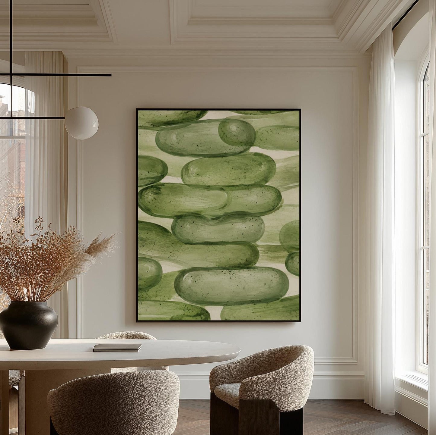 Stacked smooth green stones painted in watercolor, canvas print presented in a light, minimal room