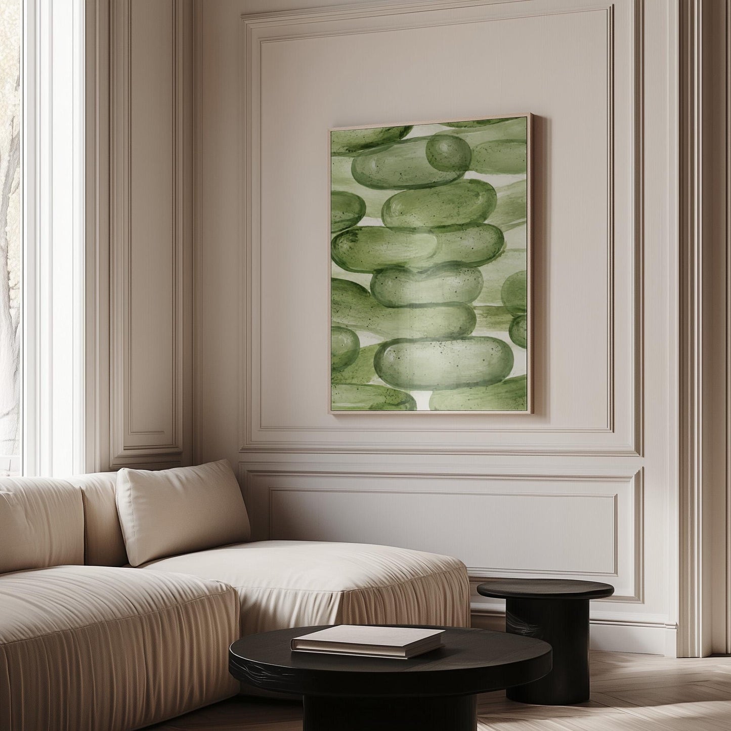 Stacked smooth green stones painted in watercolor, canvas wall art on a quiet wall in a considered interior