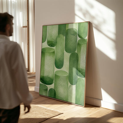 Rounded capsule shapes in layered watercolor greens, canvas print presented in a light, minimal room