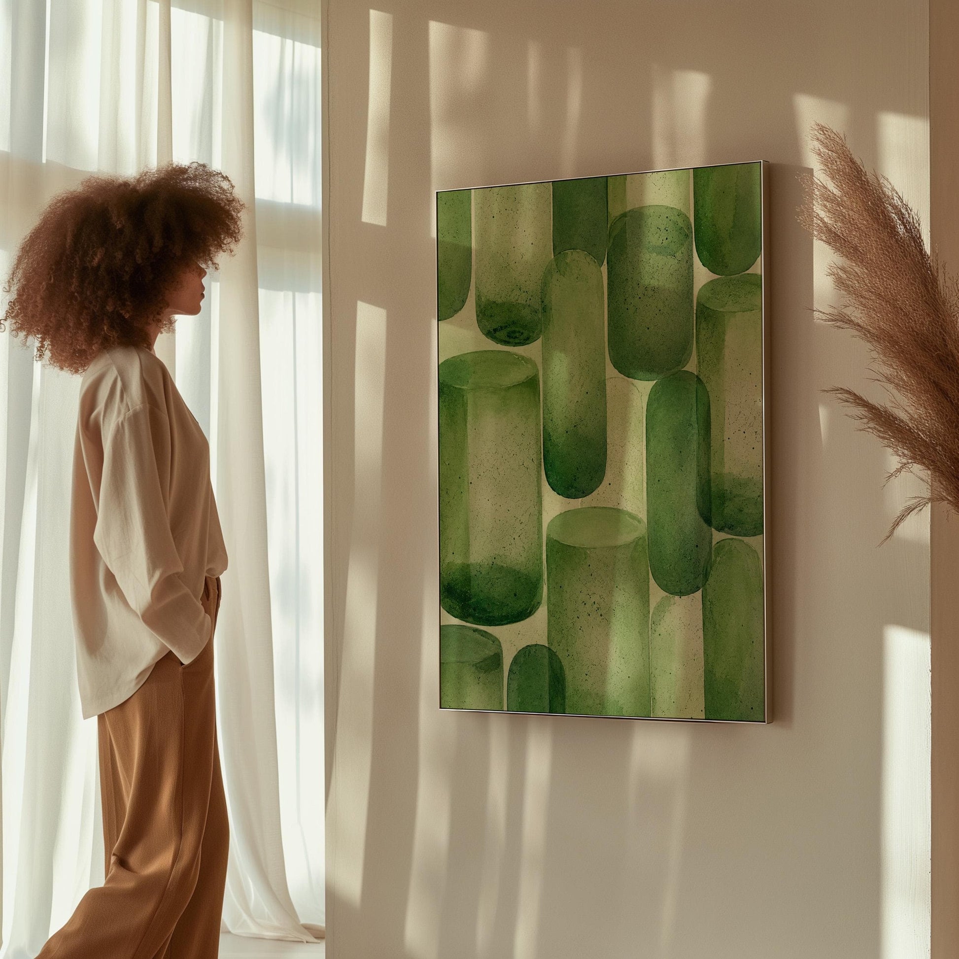 Rounded capsule shapes in layered watercolor greens, canvas print displayed on a neutral wall in a styled interior