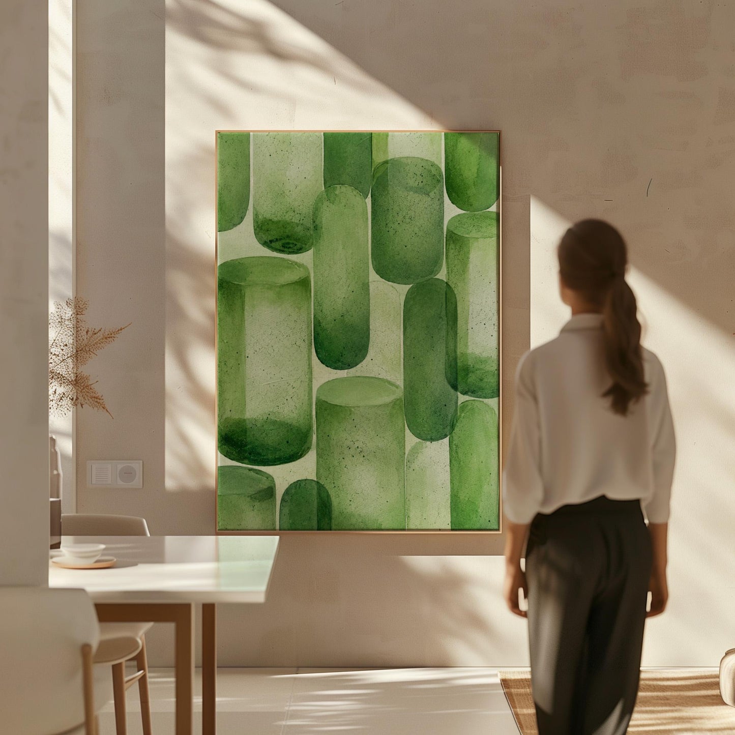 Rounded capsule shapes in layered watercolor greens, canvas wall art styled against a soft white wall
