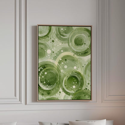 Rings and bubbles swirling in sage green watercolor, canvas print in a bright room with natural daylight