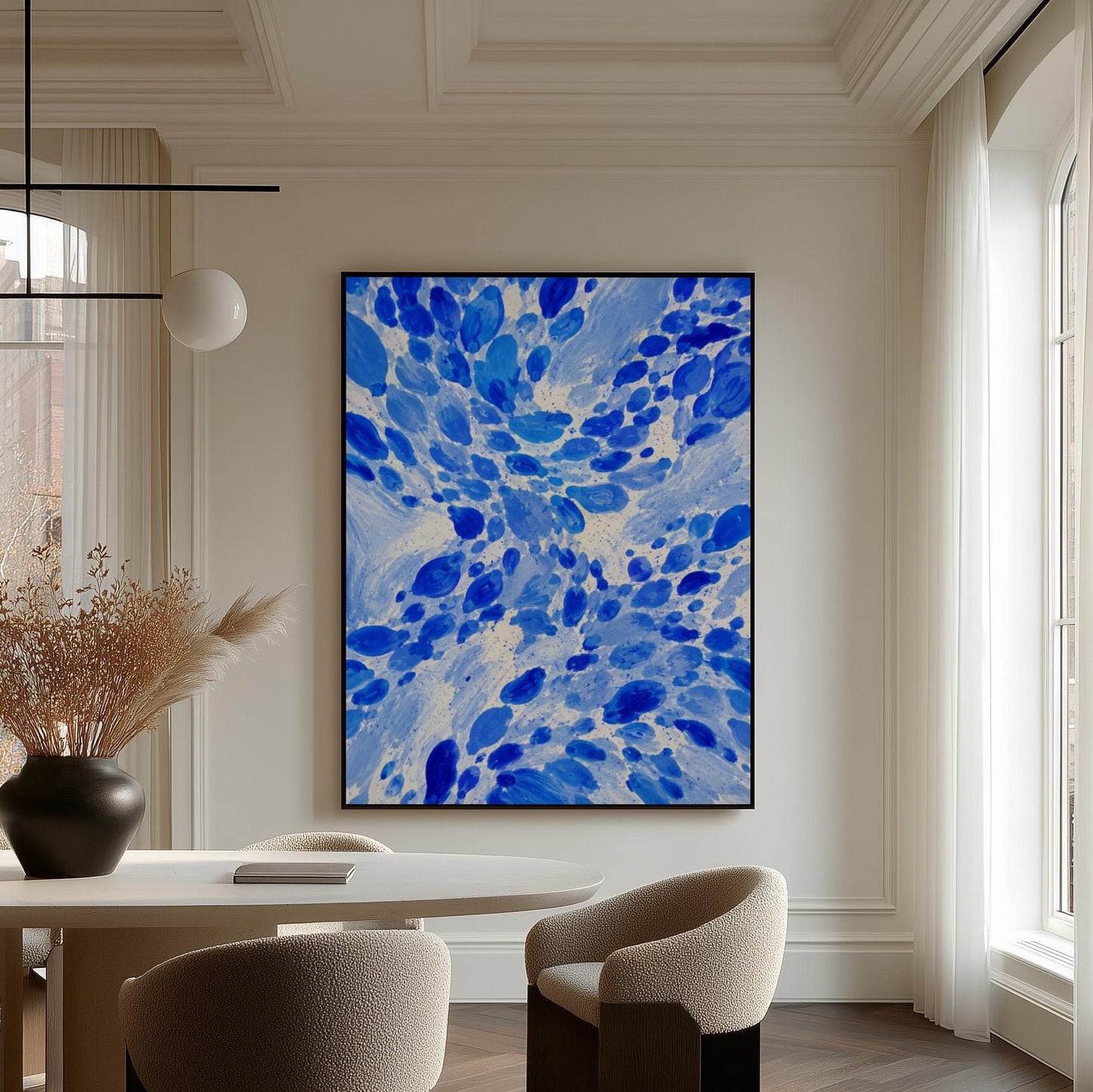 Burst of cobalt blue droplets scattering across pale background, canvas print displayed on a neutral wall in a styled interior
