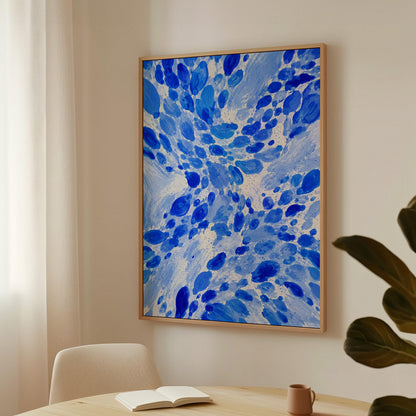 Burst of cobalt blue droplets scattering across pale background, canvas wall art presented in a light, minimal room