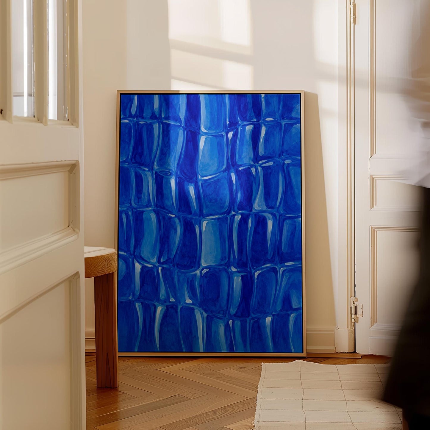 Mosaic of rounded royal blue shapes like cobblestones, canvas print shown to scale in a furnished room