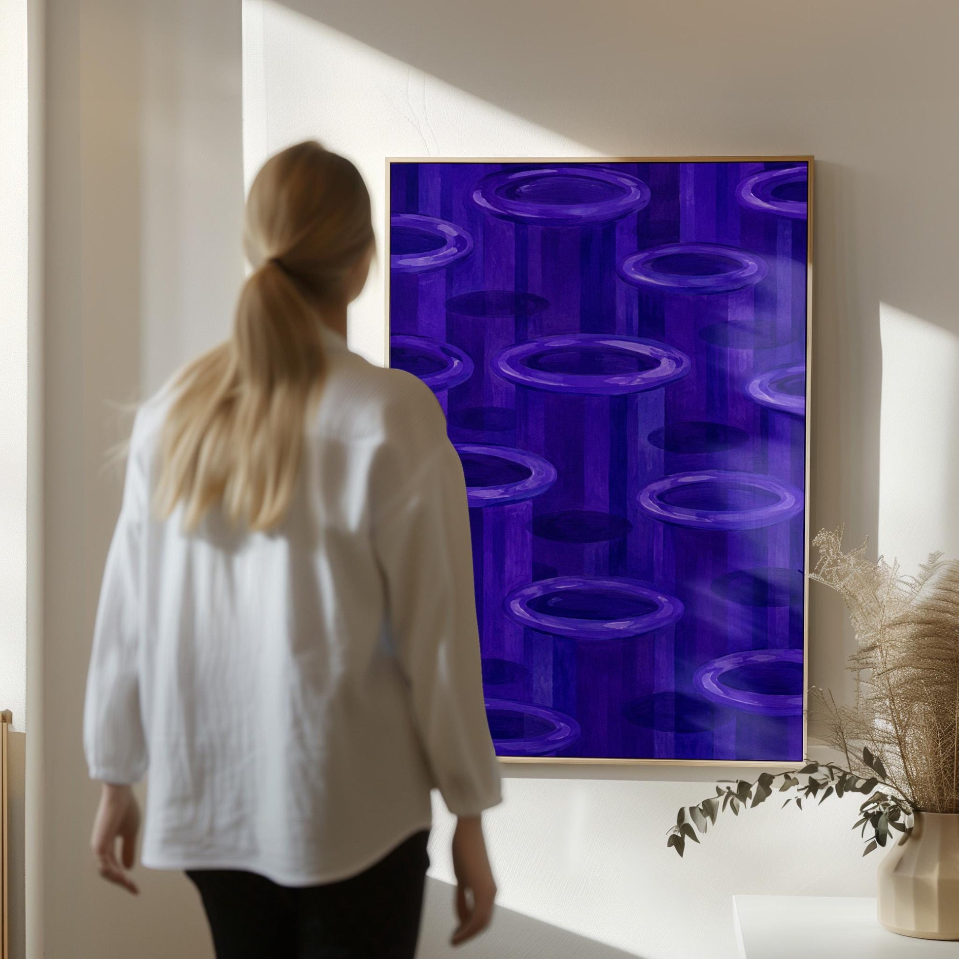 Rings emerging from deep violet and amethyst tones, canvas print hanging in a calm, modern living space