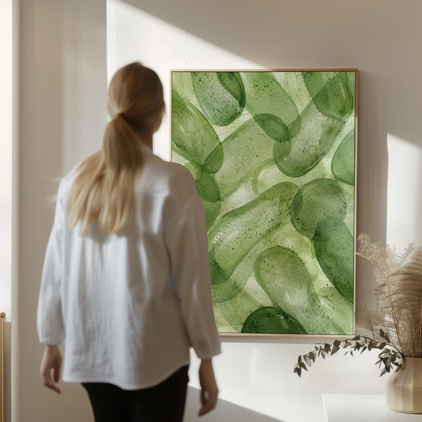 Interlaced looping rings in transparent greens, canvas print displayed on a neutral wall in a styled interior