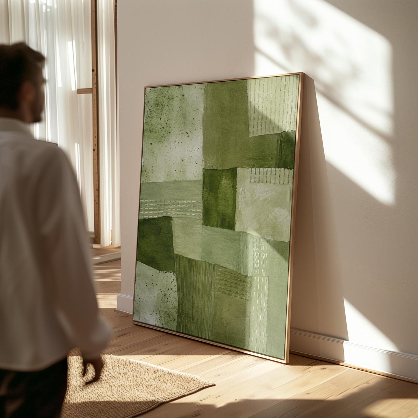 Patchwork of olive and moss green field blocks, canvas print seen in a warm interior with natural light
