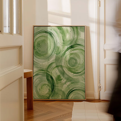 Concentric ripple rings in soft watercolor greens, canvas print shown in a sunlit, contemporary room