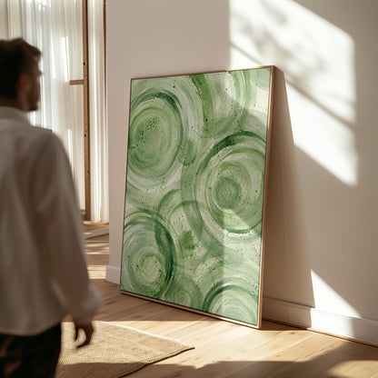 Concentric ripple rings in soft watercolor greens, canvas wall art hanging in a calm, modern living space