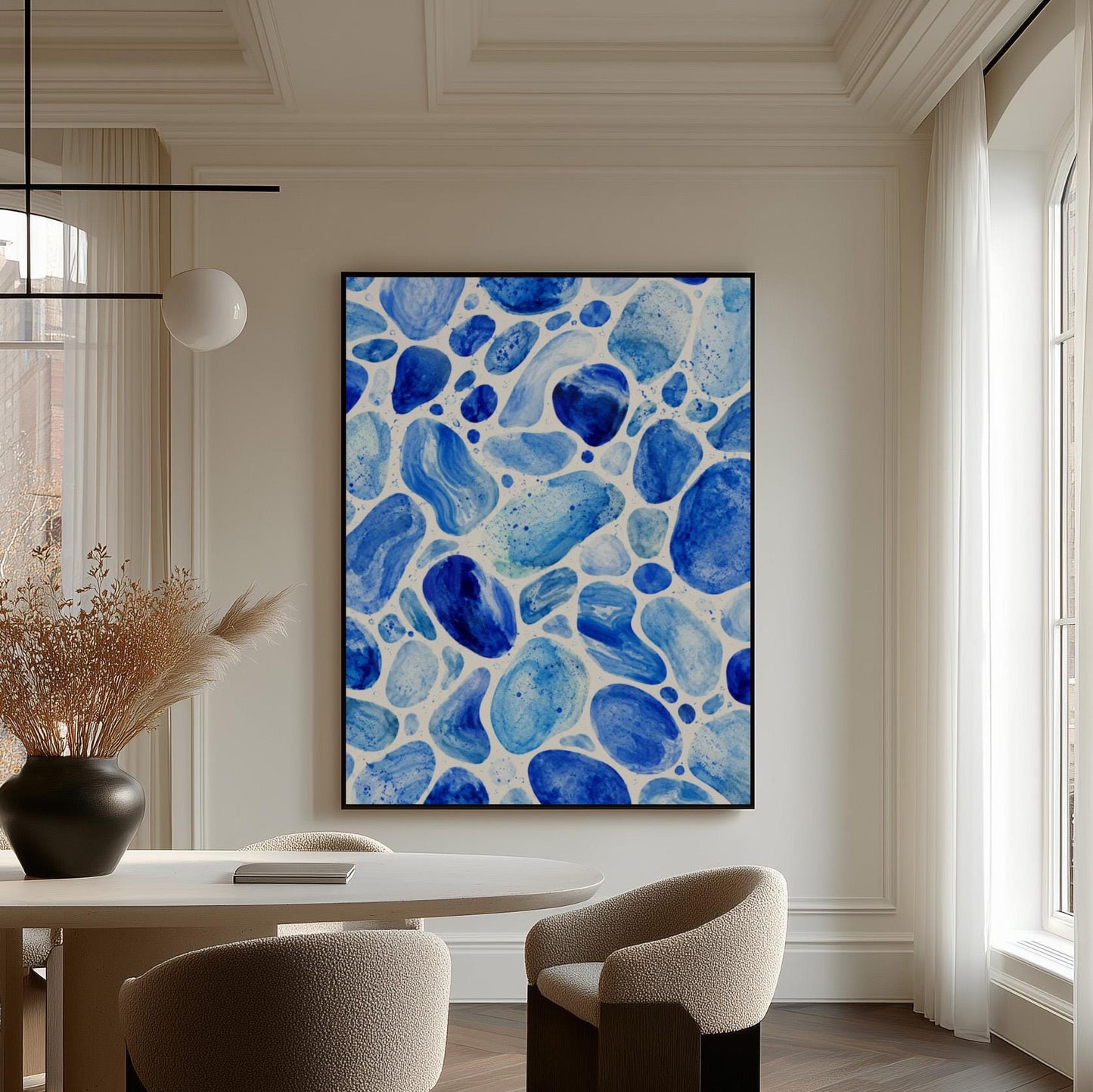 Watercolor pebbles in shades of sky blue and cobalt, canvas wall art styled against a soft white wall
