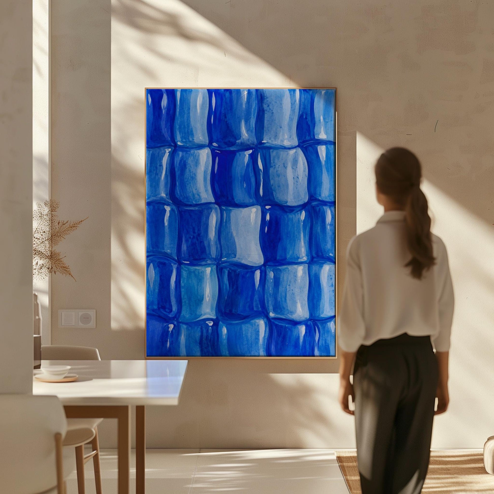 Grid of rounded squares in layered cobalt blues, canvas print on a quiet wall in a considered interior