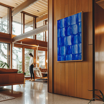 Grid of rounded squares in layered cobalt blues, canvas print displayed on a neutral wall in a styled interior