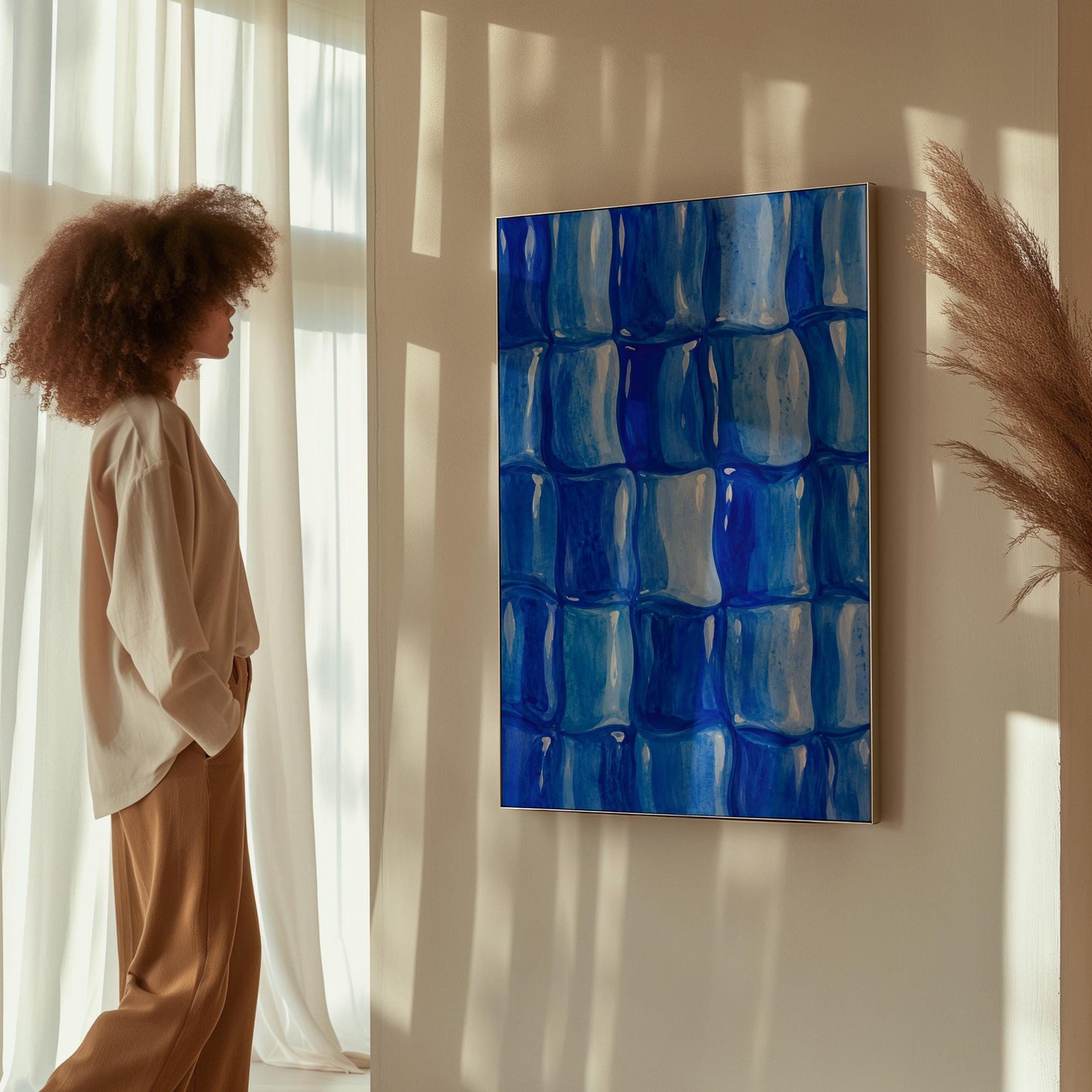 Grid of rounded squares in layered cobalt blues, canvas wall art seen in a warm interior with natural light