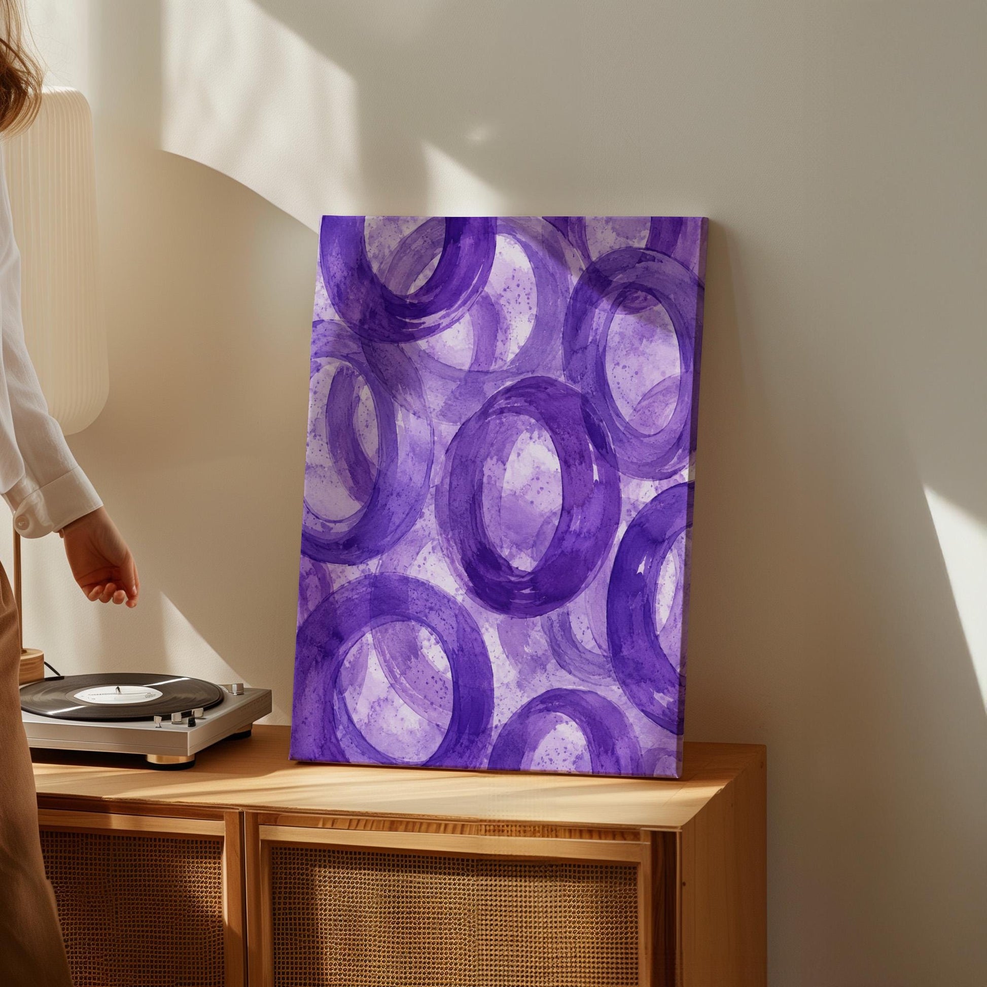 Swirling amethyst purple rings on pale background, canvas print shown to scale in a furnished room