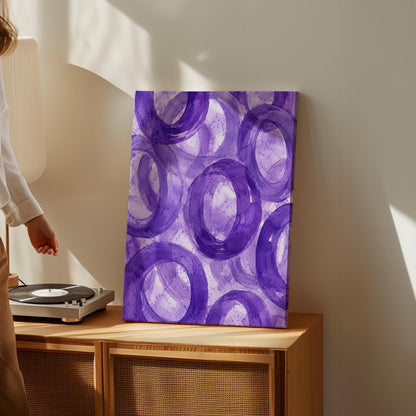 Swirling amethyst purple rings on pale background, canvas print shown to scale in a furnished room
