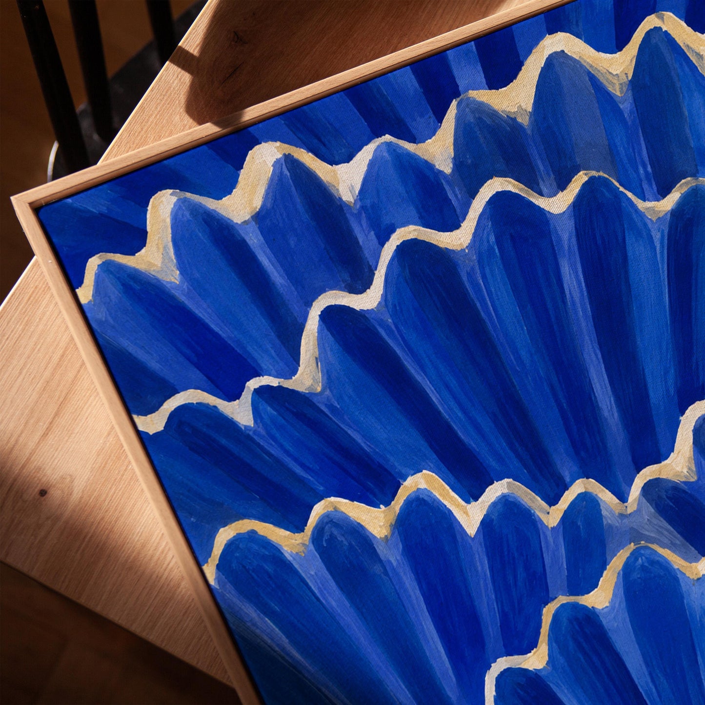 Fan shaped scallop shells in cobalt with gold edges, canvas print in a warm, minimally styled interior