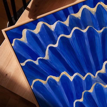Fan shaped scallop shells in cobalt with gold edges, canvas print in a warm, minimally styled interior
