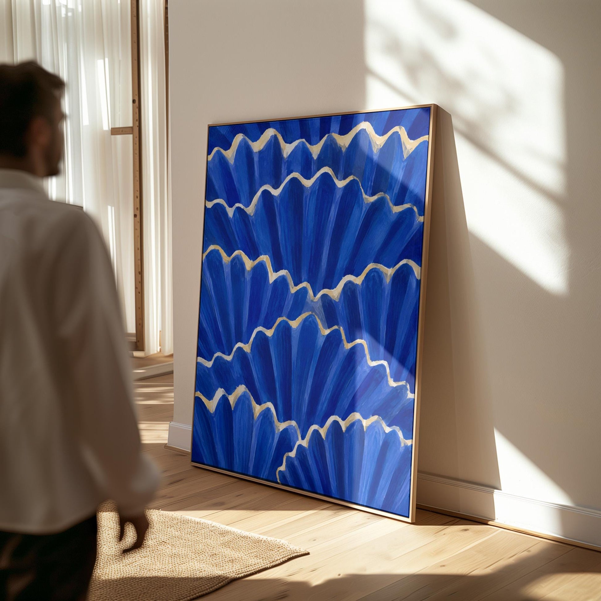 Fan shaped scallop shells in cobalt with gold edges, canvas print hanging in a calm, modern living space