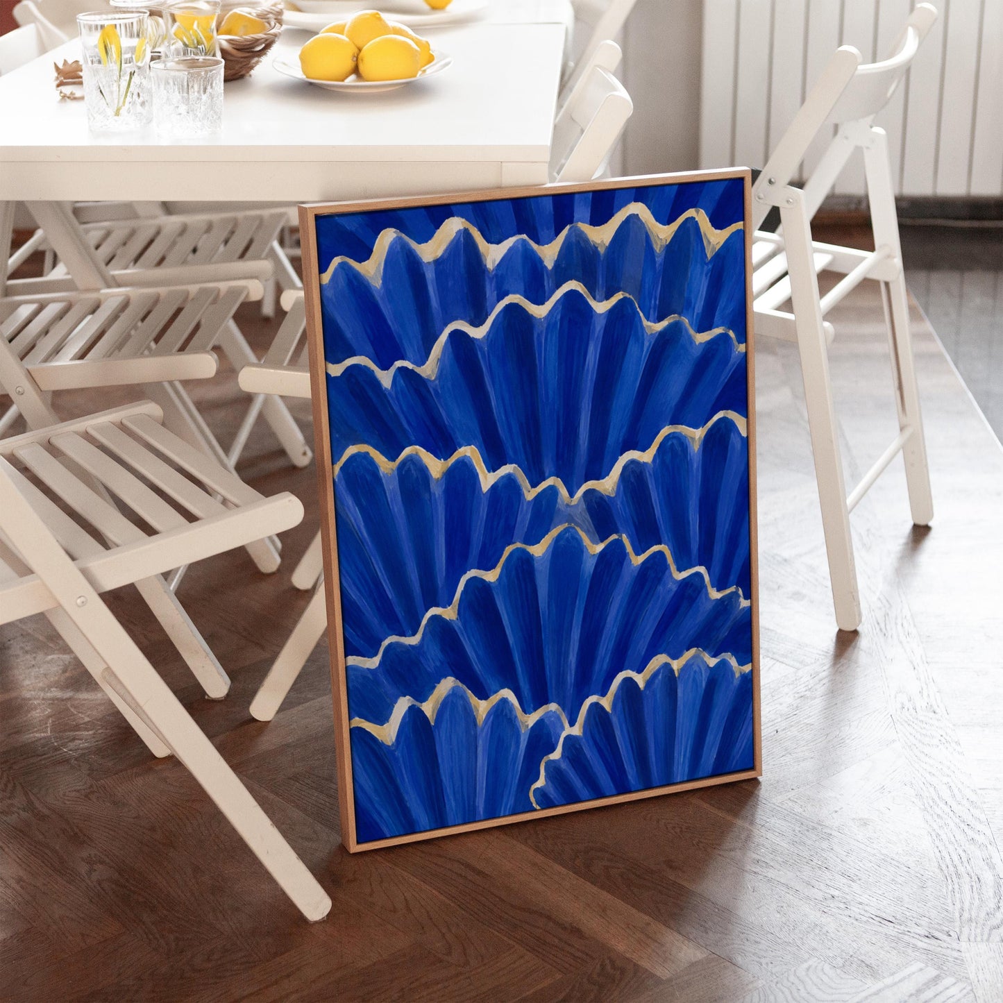 Fan shaped scallop shells in cobalt with gold edges, canvas print styled against a soft white wall