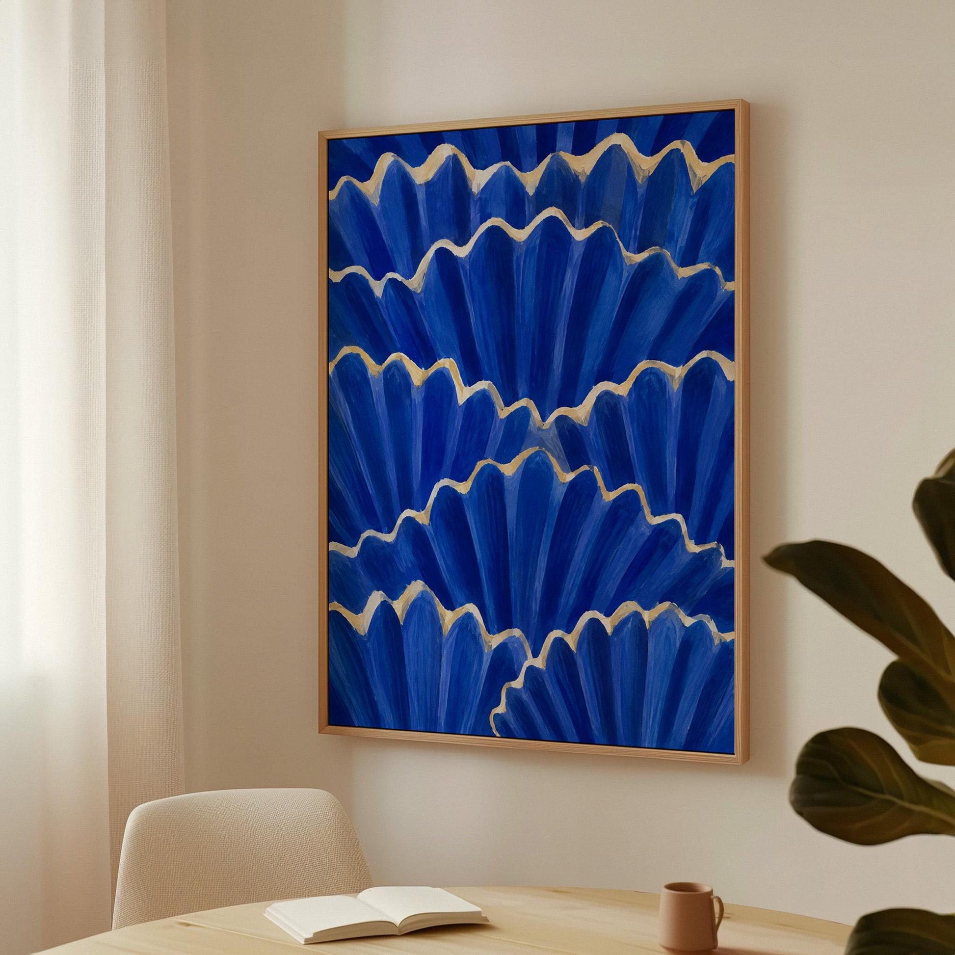 Fan shaped scallop shells in cobalt with gold edges, canvas wall art hanging in a calm, modern living space